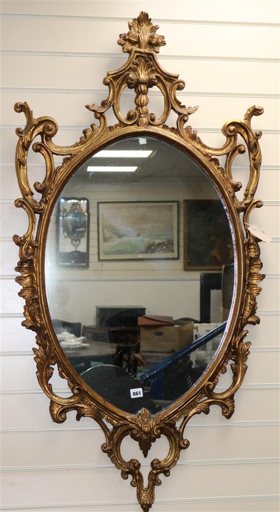 A pair of carved gilt-framed oval wall mirrors W.67cm